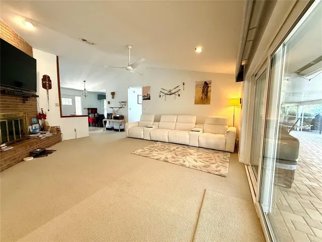a living room with furniture ceiling fan and a window