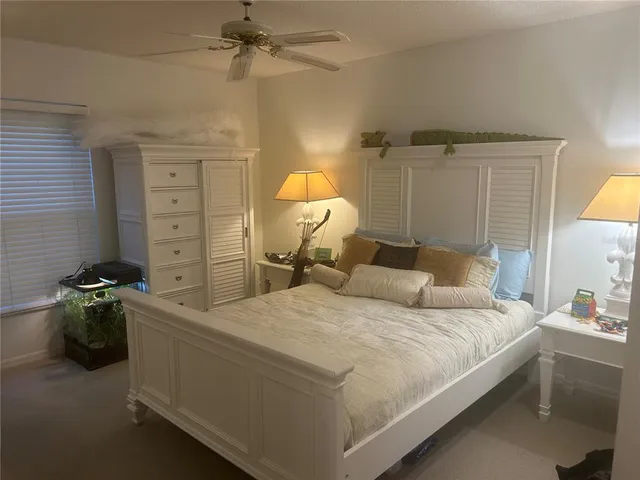 a spacious bedroom with a bed and a chandelier