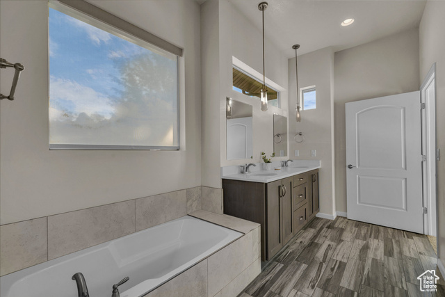 101 Chuckwalla Lane Springdale, UT 84767 - Photo 13 of 51 Full bathroom featuring double vanity, a garden tub, and dark wood-style floors