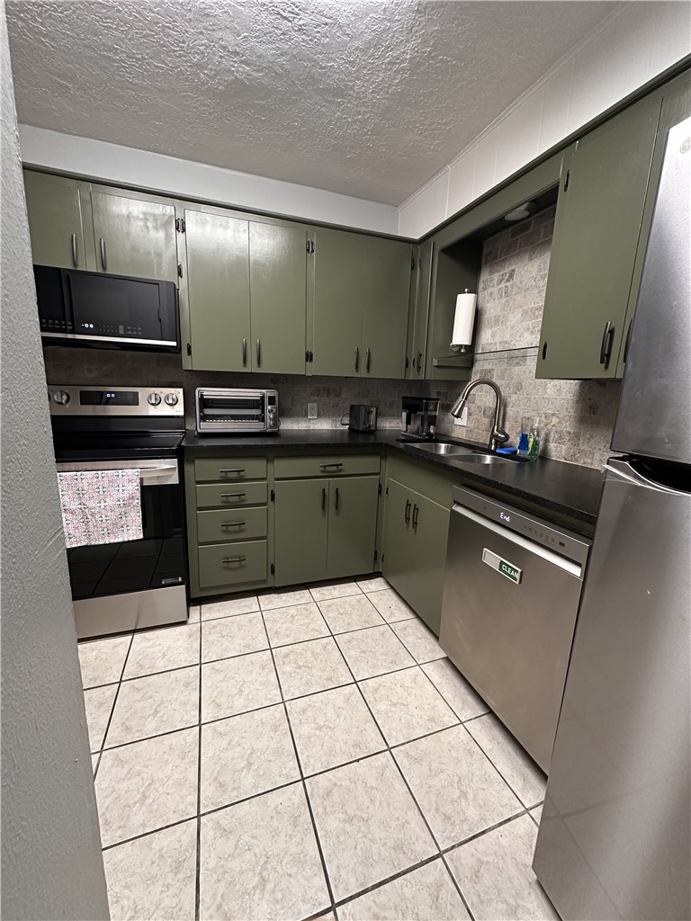3820 Plainsman Lane Bryan, TX 77802 - Photo 11 of 20 a kitchen with granite countertop a sink and a stove top oven