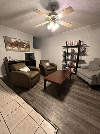 a living room with furniture and a chandelier