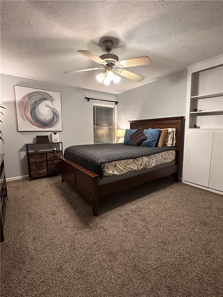 3820 Plainsman Lane Bryan, TX 77802 - Photo 2 of 20 a spacious bedroom with a bed and a chandelier