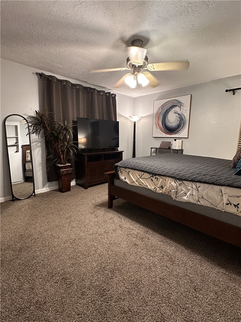 3820 Plainsman Lane Bryan, TX 77802 - Photo 3 of 20 a living room with furniture a flat screen tv and kitchen view