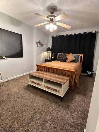 a spacious bedroom with a bed and a chandelier