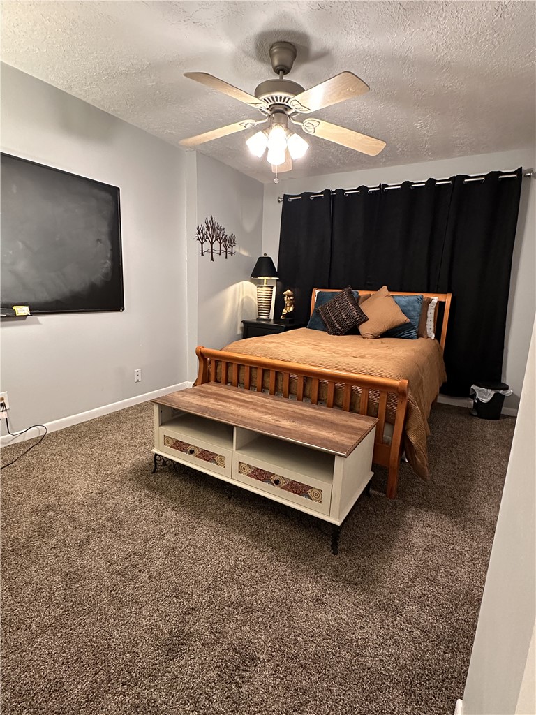 3820 Plainsman Lane Bryan, TX 77802 - Photo 5 of 20 a spacious bedroom with a bed and a chandelier