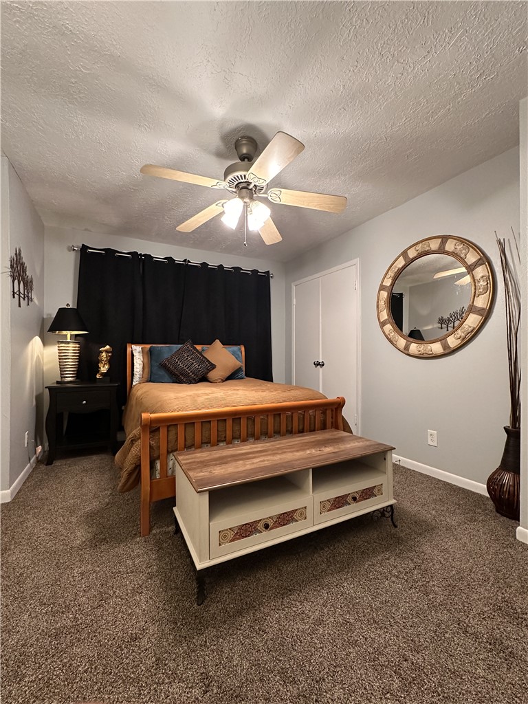 3820 Plainsman Lane Bryan, TX 77802 - Photo 6 of 20 a bedroom with a bed and a chandelier