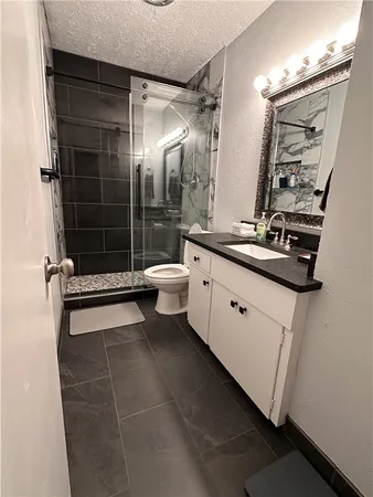 a bathroom with a double vanity sink toilet and shower