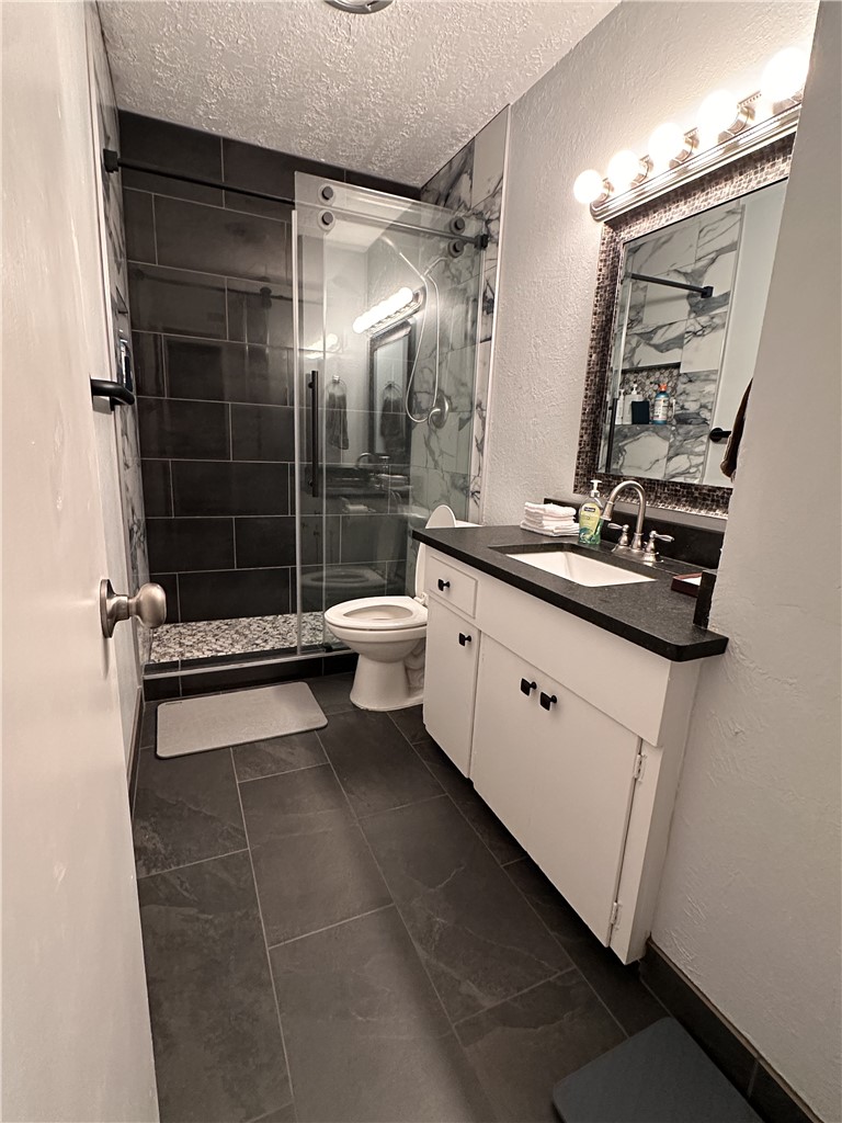 3820 Plainsman Lane Bryan, TX 77802 - Photo 7 of 20 a bathroom with a double vanity sink toilet and shower