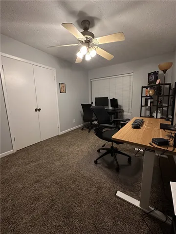 a room with gym equipment and a ceiling fan