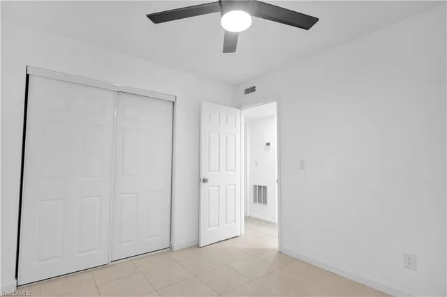 an empty room with a ceiling fan
