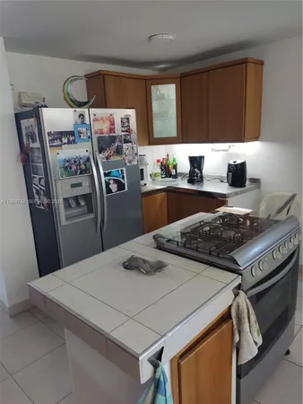 a kitchen with stainless steel appliances granite countertop a stove a refrigerator and a stove
