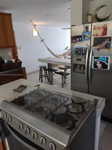 a kitchen with a stove and a refrigerator