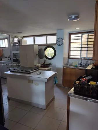a kitchen with stainless steel appliances granite countertop a sink a stove and a wooden floors