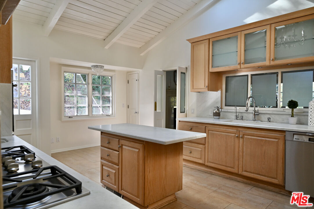 15946 Valley Wood Road Sherman Oaks, CA 91403 - Photo 11 of 23 a kitchen with a sink stove and cabinets