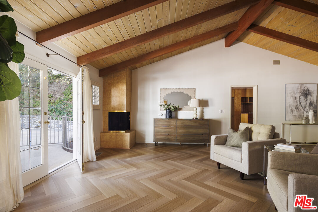 15946 Valley Wood Road Sherman Oaks, CA 91403 - Photo 12 of 23 a living room with furniture and a large window