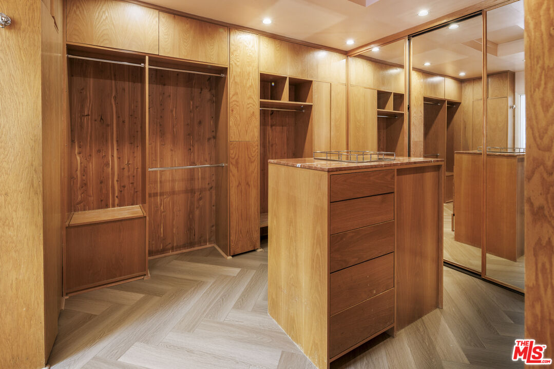 15946 Valley Wood Road Sherman Oaks, CA 91403 - Photo 14 of 23 a view of walk in closet with empty racks