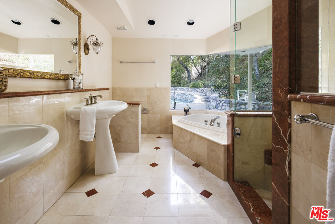 15946 Valley Wood Road Sherman Oaks, CA 91403 - Photo 15 of 23 a large white kitchen with a large window