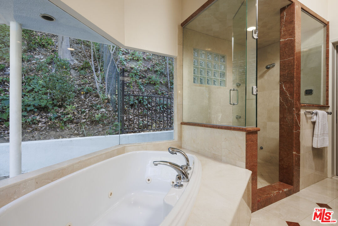 15946 Valley Wood Road Sherman Oaks, CA 91403 - Photo 16 of 23 a bathroom with a bathtub and shower
