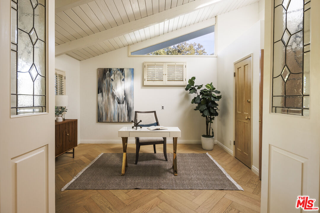 15946 Valley Wood Road Sherman Oaks, CA 91403 - Photo 4 of 23 a workspace with furniture and a potted plant
