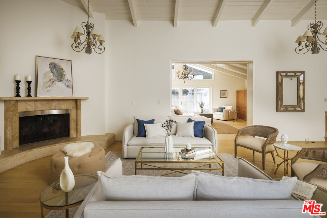 15946 Valley Wood Road Sherman Oaks, CA 91403 - Photo 5 of 23 a living room with furniture and a fireplace