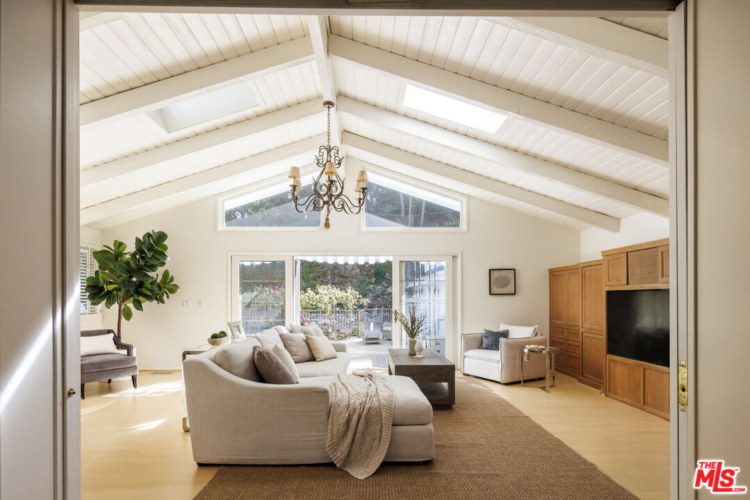 15946 Valley Wood Road Sherman Oaks, CA 91403 - Photo 6 of 23 a living room with furniture and a flat screen tv