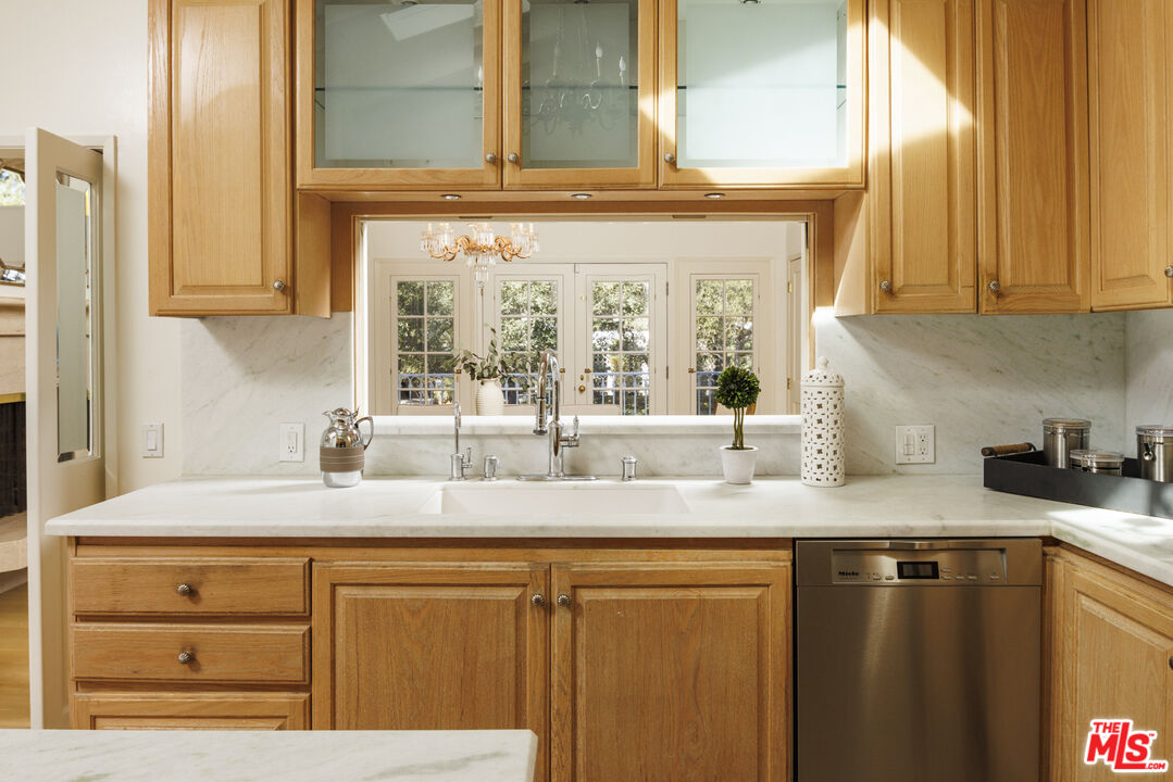 15946 Valley Wood Road Sherman Oaks, CA 91403 - Photo 10 of 23 a kitchen with granite countertop cabinets and window