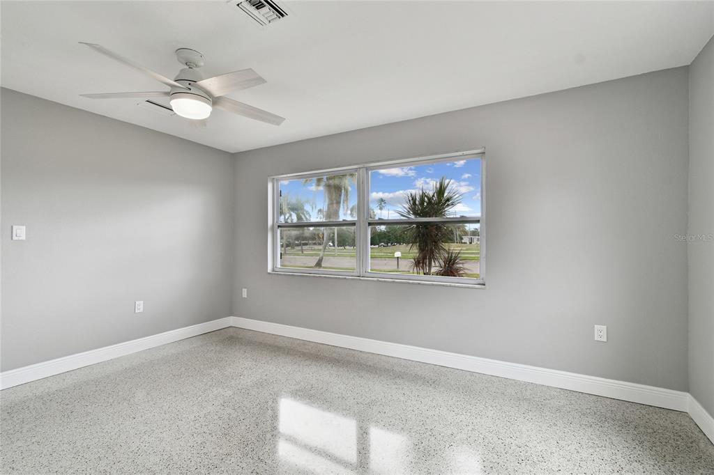 623 Palm Boulevard Dunedin, FL 34698 - Photo 15 of 55 a view of wooden floor and a chandelier fan in a room
