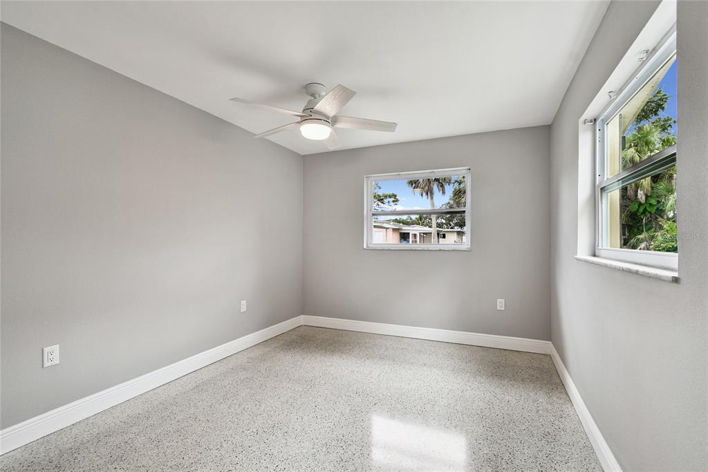 623 Palm Boulevard Dunedin, FL 34698 - Photo 23 of 55 an empty room with windows and fan