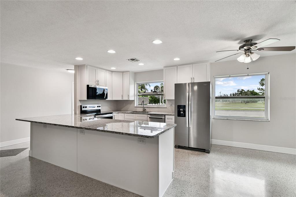 623 Palm Boulevard Dunedin, FL 34698 - Photo 4 of 55 a kitchen with stainless steel appliances a refrigerator sink and microwave