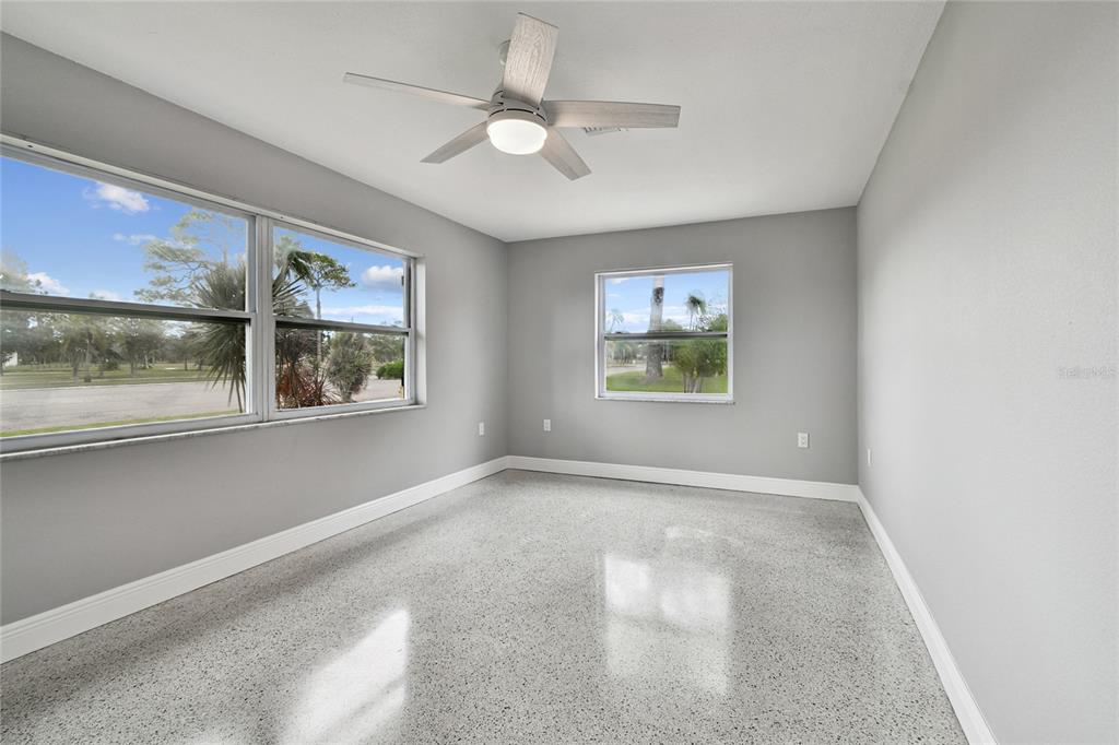 623 Palm Boulevard Dunedin, FL 34698 - Photo 10 of 55 an empty room with windows and ceiling fan
