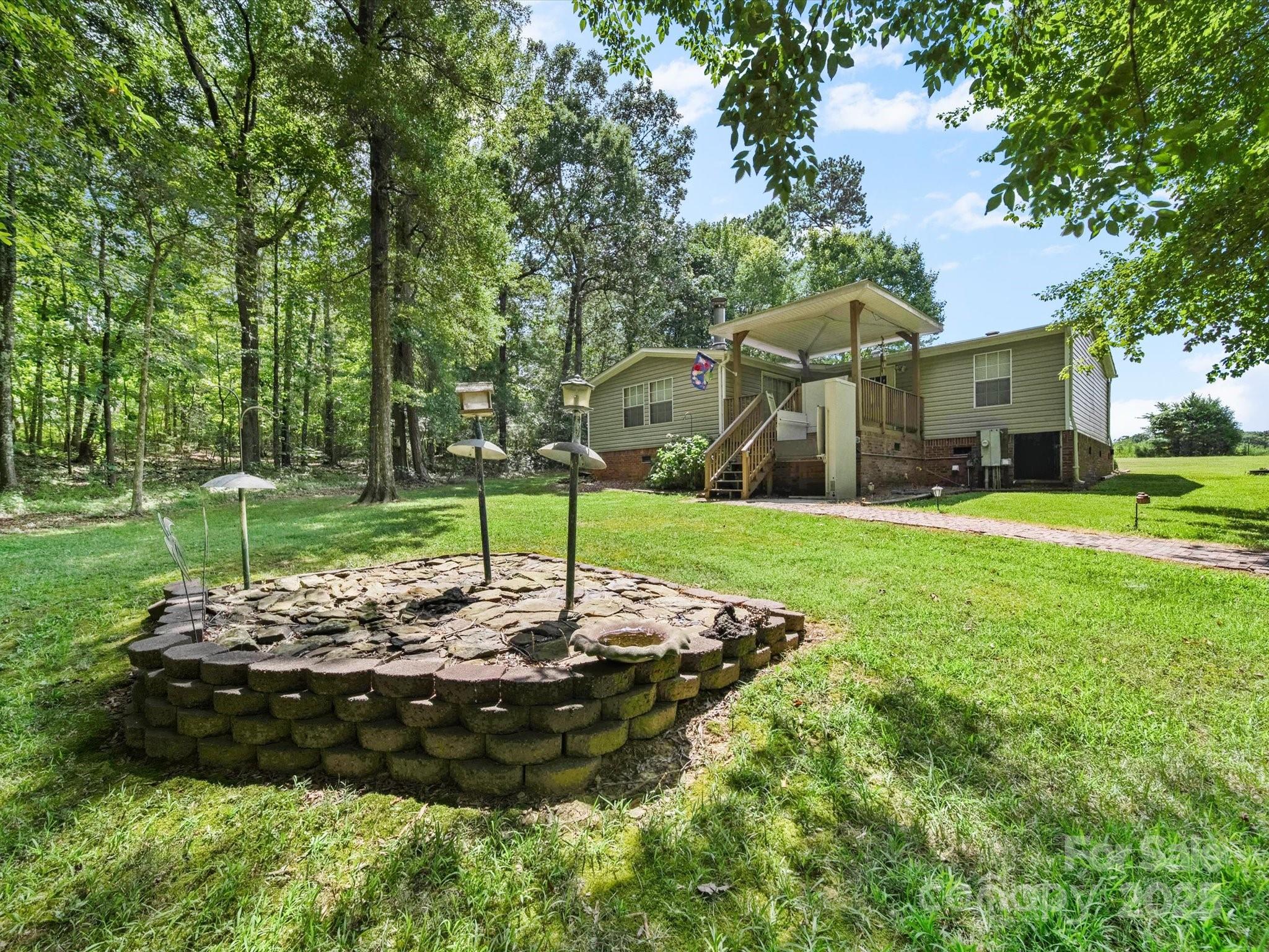 3911 Doster Road Monroe, NC 28112 - Photo 12 of 34 a view of a house with a yard
