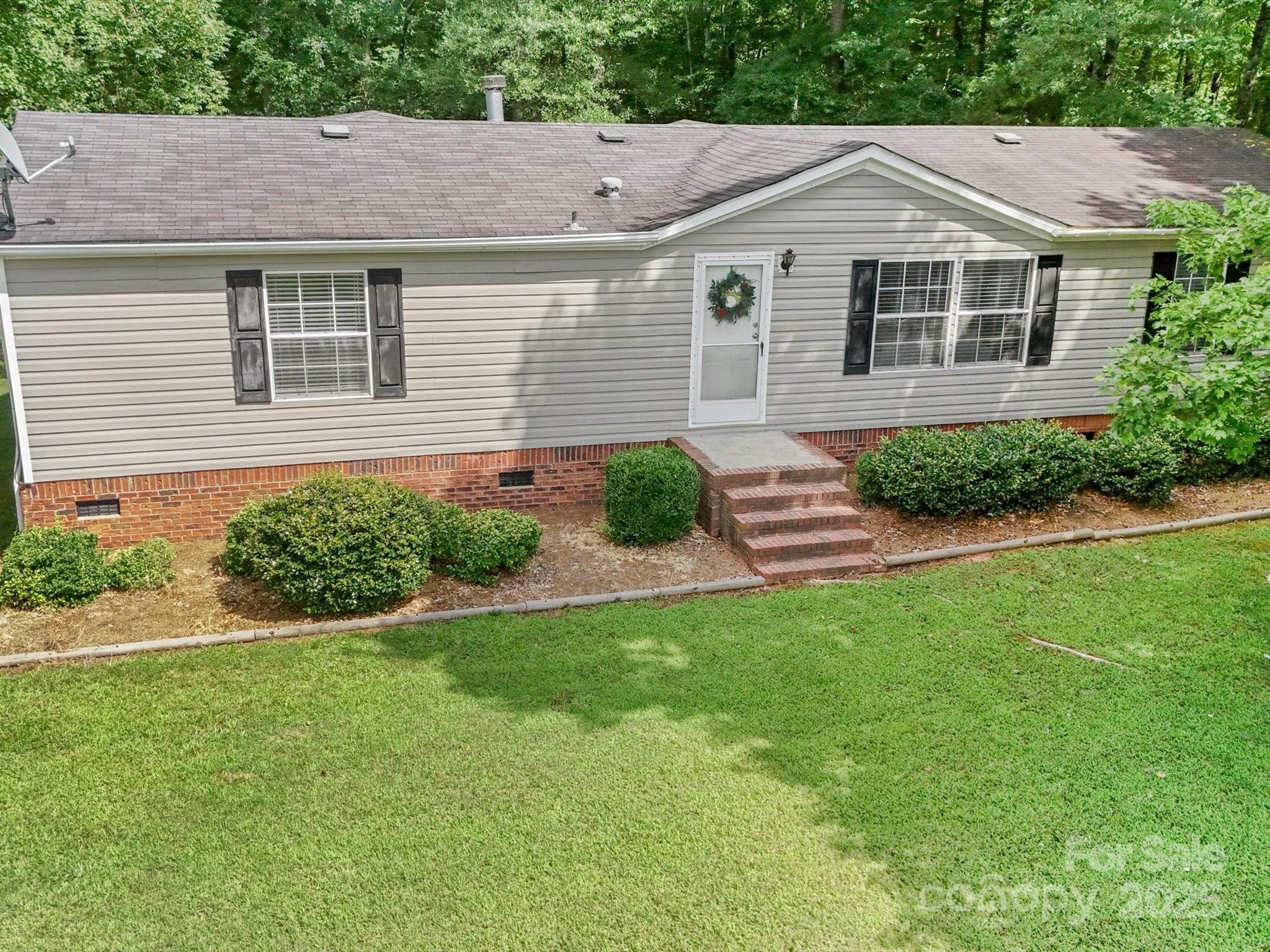 3911 Doster Road Monroe, NC 28112 - Photo 2 of 34 a front view of a house with garden