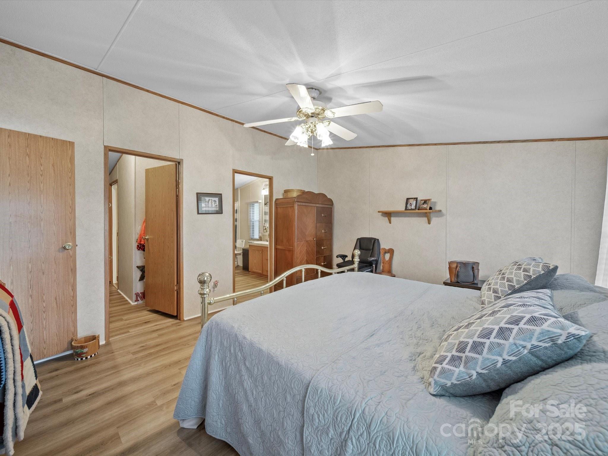 3911 Doster Road Monroe, NC 28112 - Photo 26 of 34 a bedroom with a bed and a chandelier