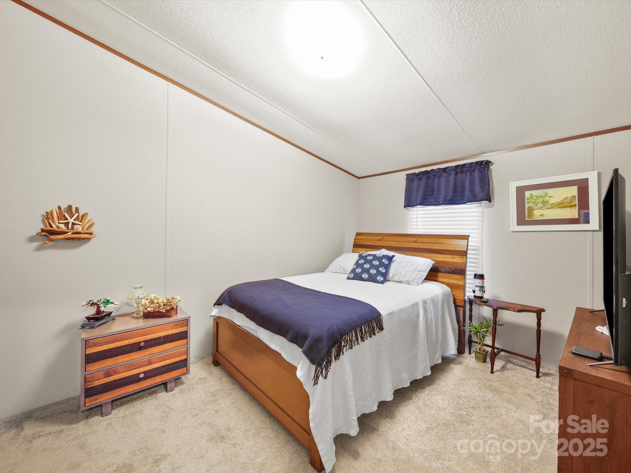 3911 Doster Road Monroe, NC 28112 - Photo 31 of 34 a bedroom with a bed and a table in it