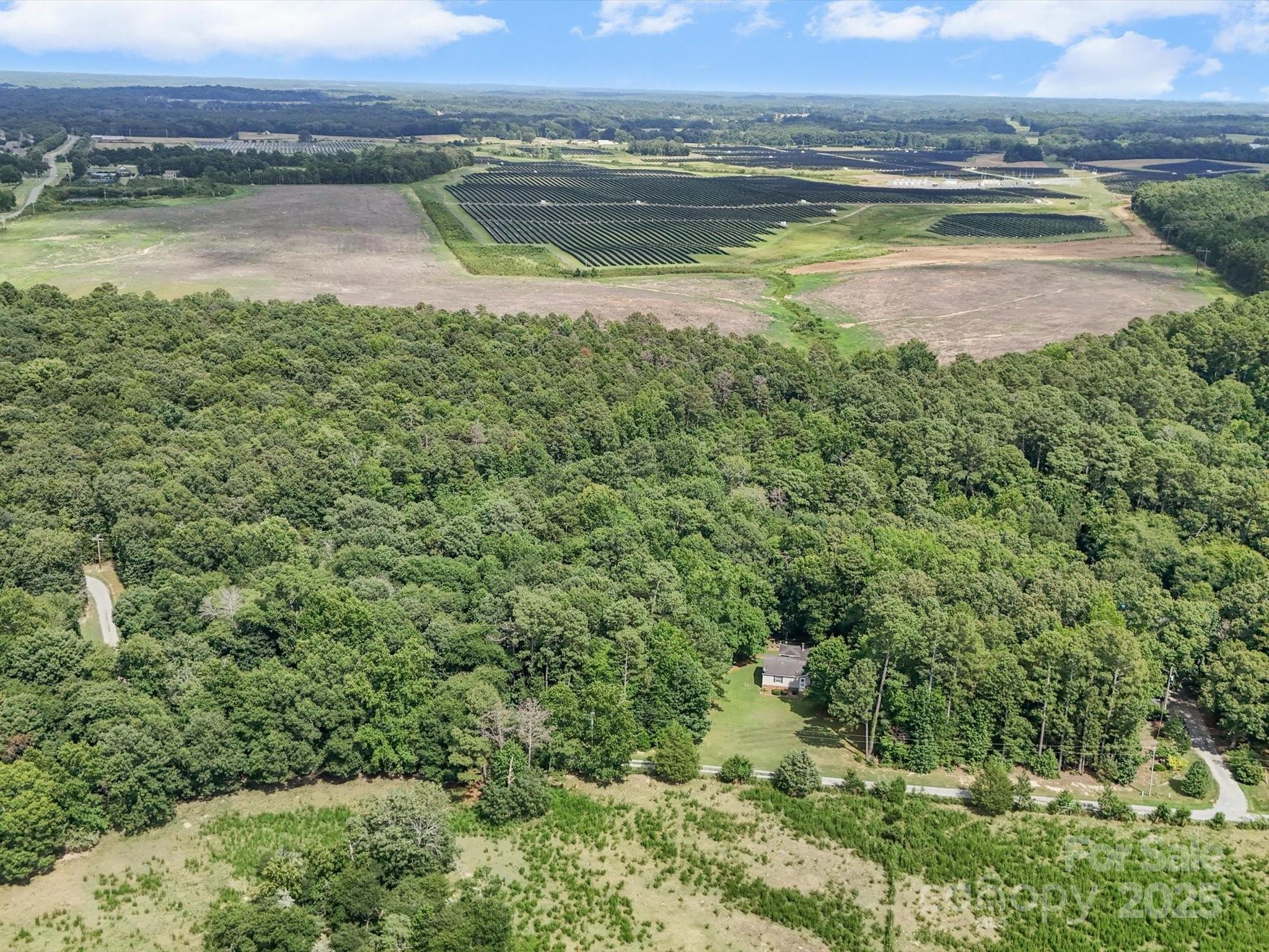 3911 Doster Road Monroe, NC 28112 - Photo 7 of 34 a view of a lake with a mountain in the background