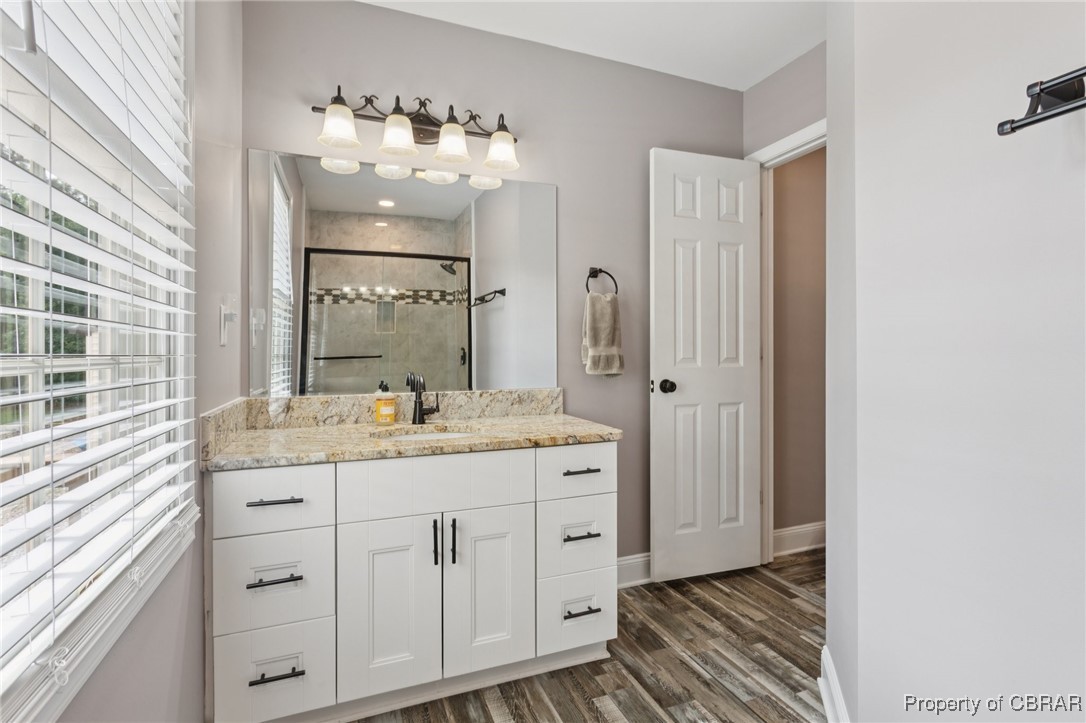 2063 Riley Lane Hayes, VA 23072 - Photo 16 of 35 Full bath with wood finished floors, a shower stall, and vanity