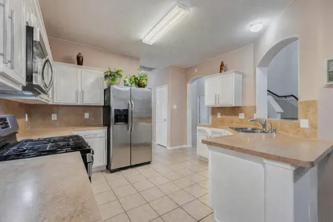 a kitchen with a sink cabinets and stainless steel appliances