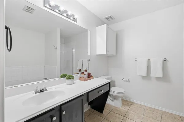 a bathroom with a sink vanity and a mirror