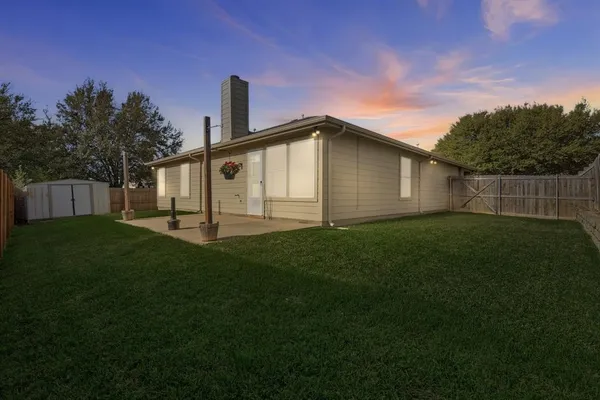 a front view of a house with a yard and garden