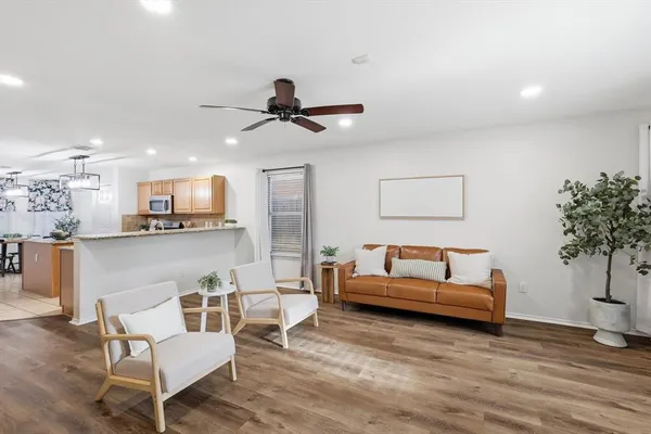 a living room with furniture and a potted plant