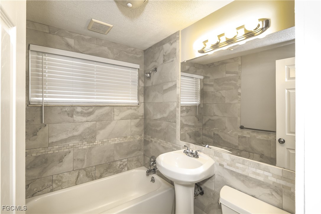 4215 Tarpon Road Venice, FL 34293 - Photo 13 of 16 a bathroom with a sink mirror toilet and bathtub