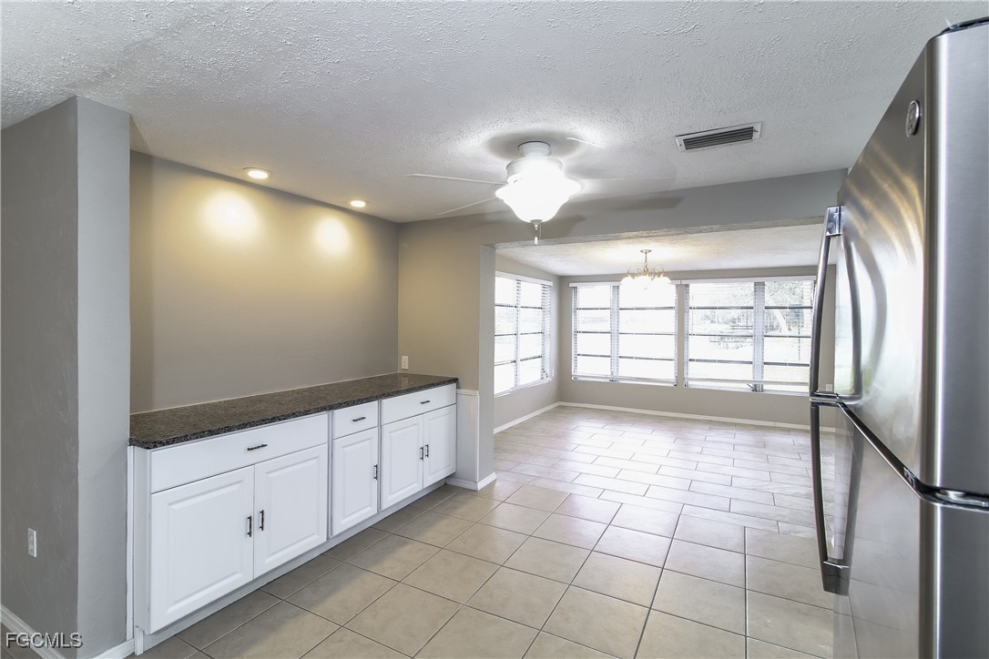 4215 Tarpon Road Venice, FL 34293 - Photo 4 of 16 a view of a big room with chandelier fan and windows
