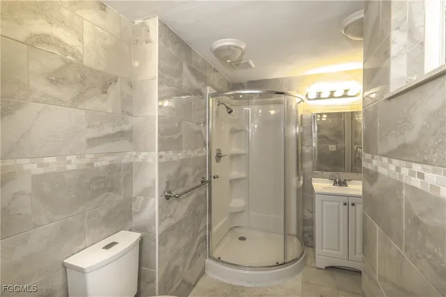a bathroom with a glass shower door