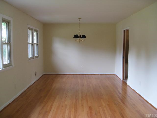 205 Reynolds Road Raleigh, NC 27609 - Photo 3 of 5 an empty room with a door