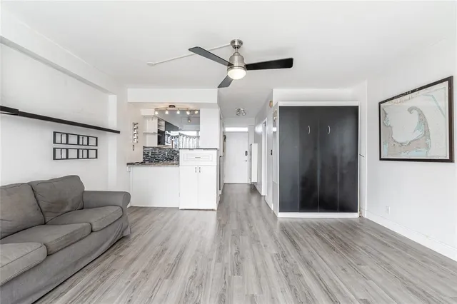 a living room with furniture and kitchen view