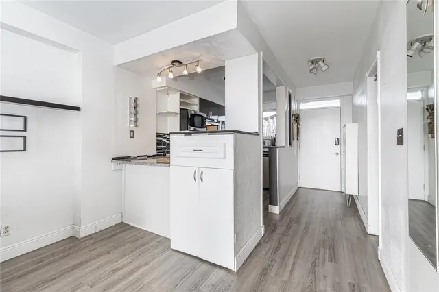a view of a kitchen with wooden floor