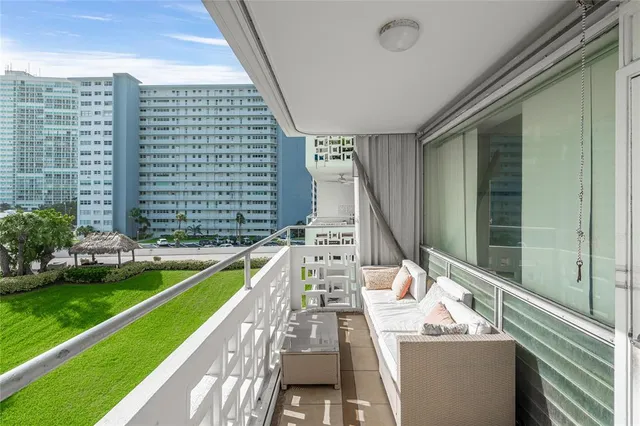 a view of a balcony with a sitting area