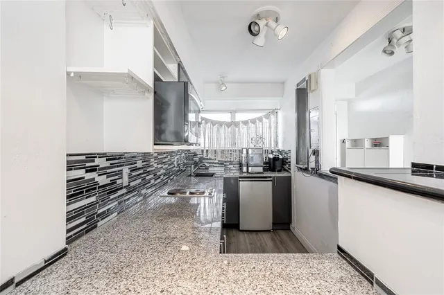 a kitchen with sink and stove