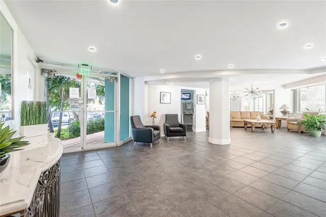 a lobby with furniture and floor to ceiling window
