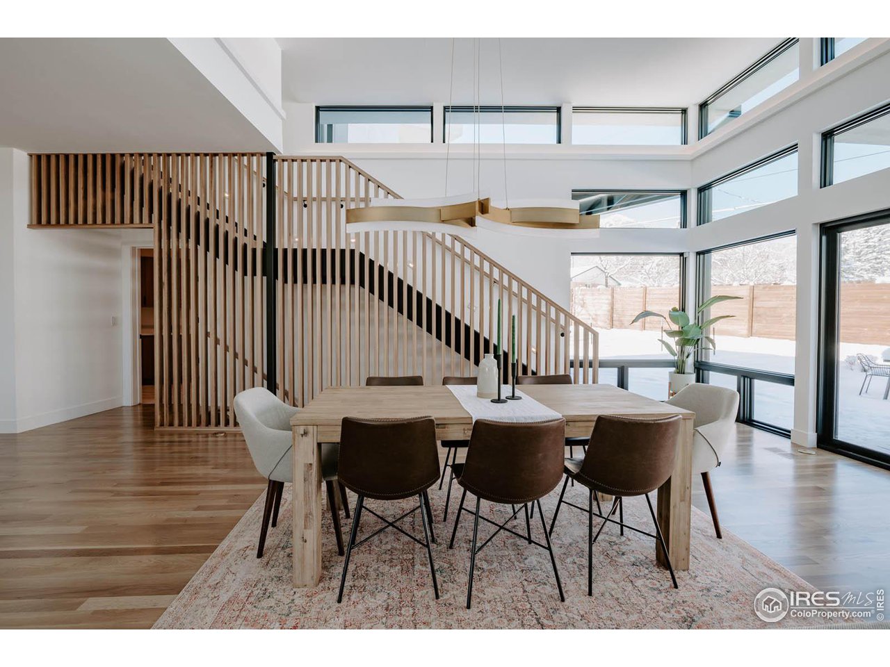 1175 Georgetown Road Boulder, CO 80305 - Photo 11 of 40 Modern but warm with this brass linear dining fixture and slat wood stair wall.
